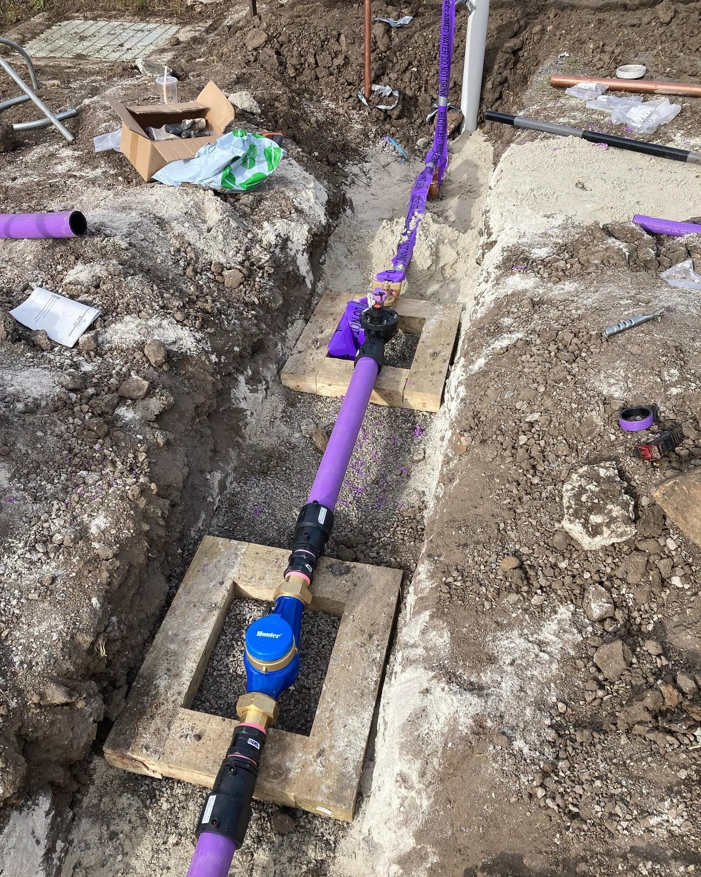 Recycled-water mainline installation showing the flow-monitoring assembly