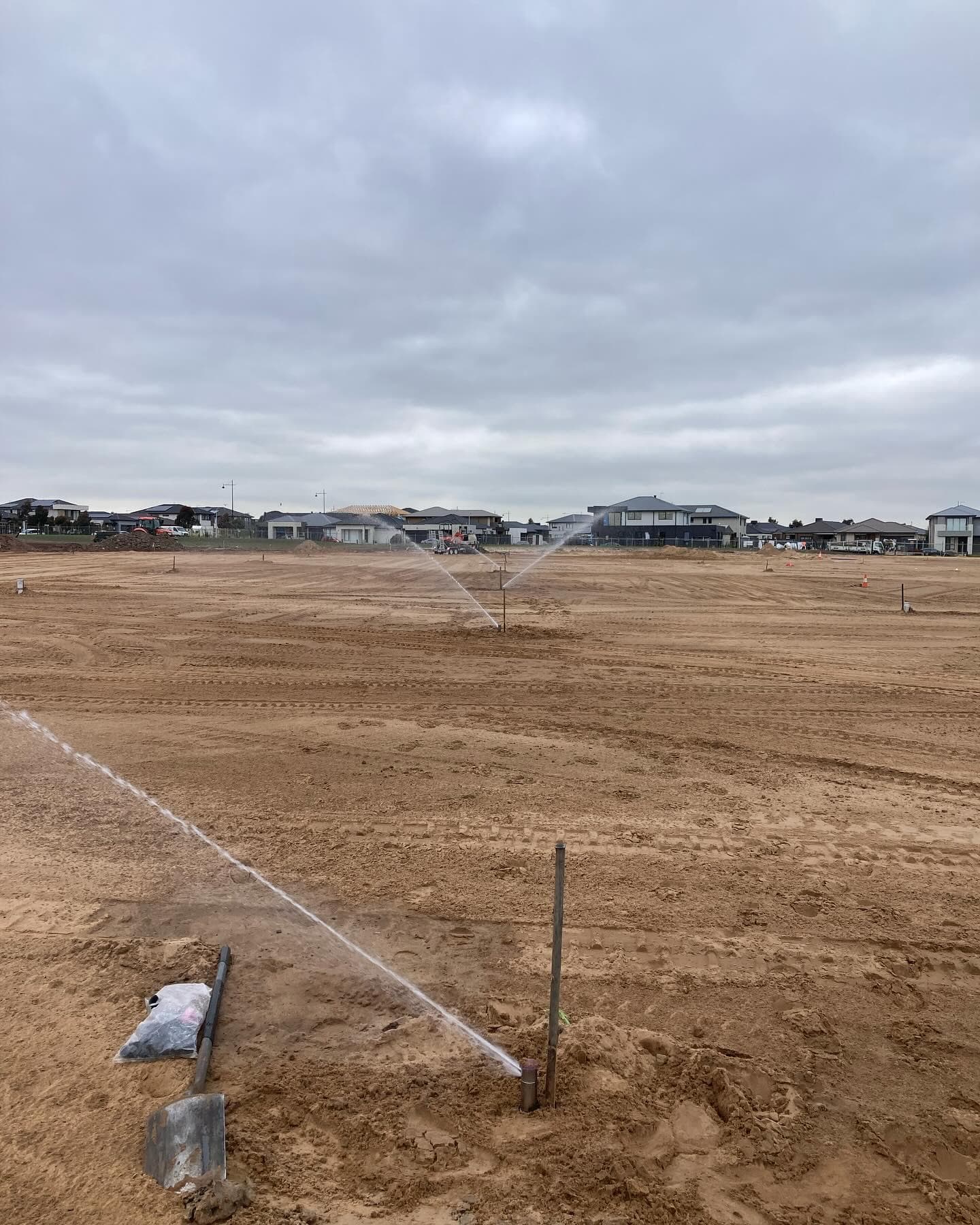 Sports field sprinklers operating during testing and coverage adjustment at Highlands Reserve