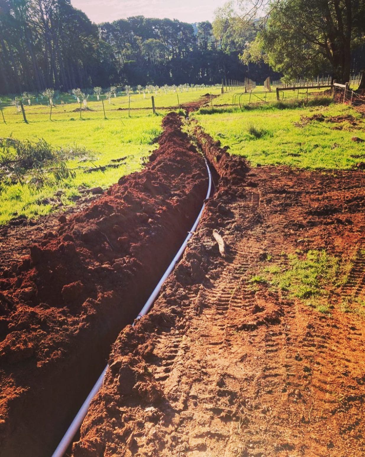 Mainline trench extending through the wider rural property