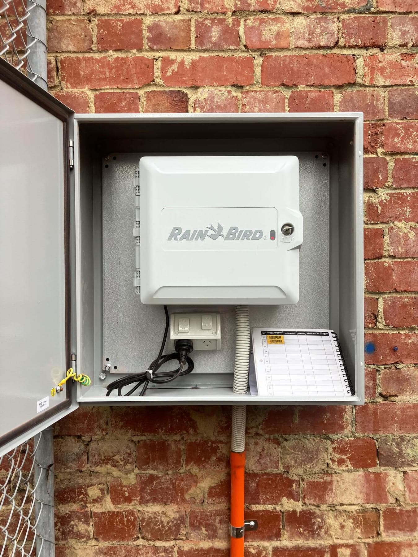 Automatic irrigation controller installed within a dedicated lockable external cabinet