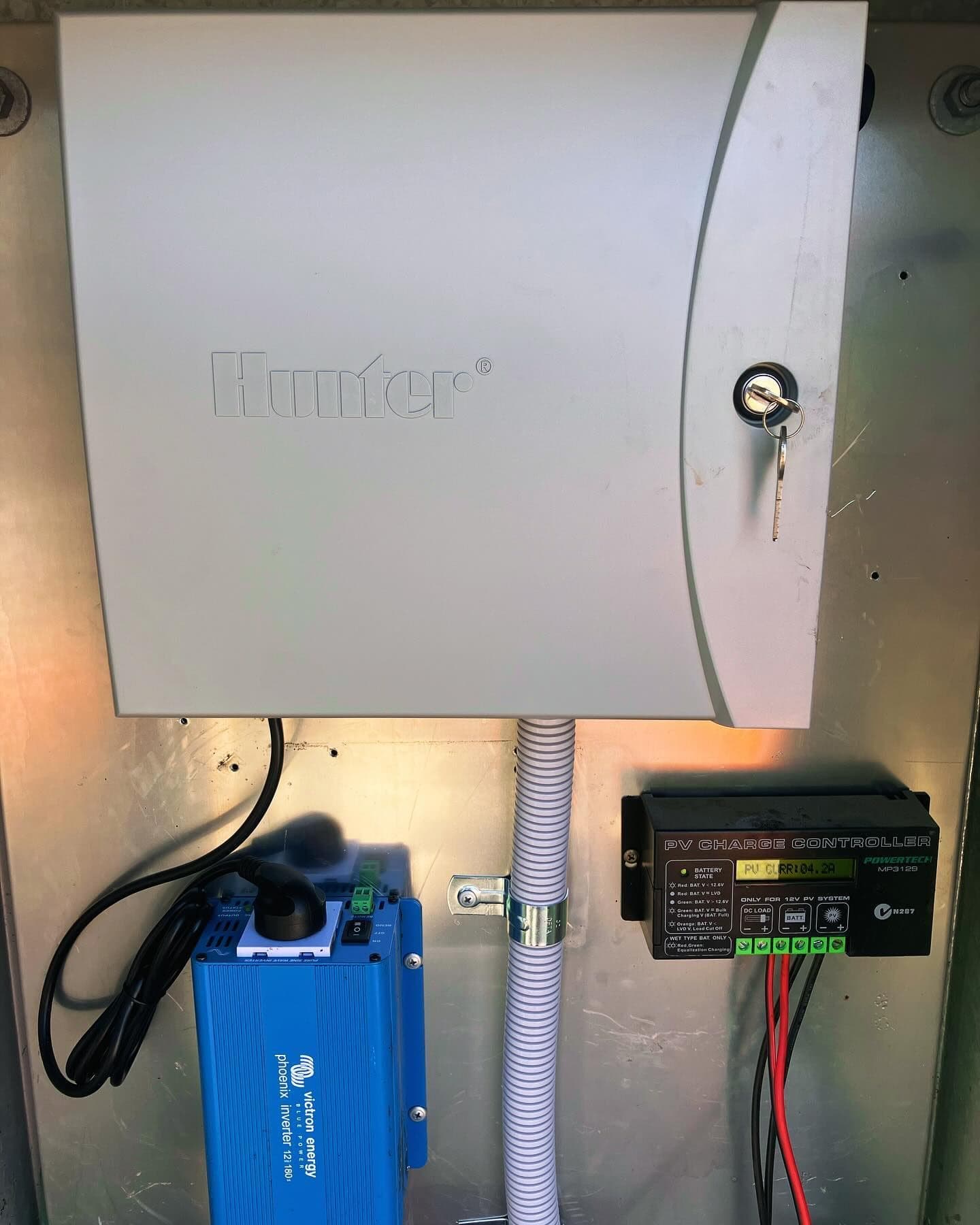 Internal solar-control cabinet showing an automatic controller, inverter and charge controller