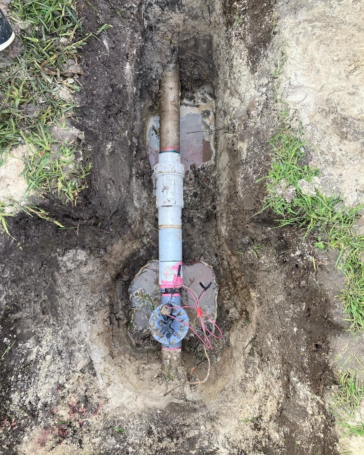 Exposed solenoid valve repair in an excavated section of an existing irrigation system