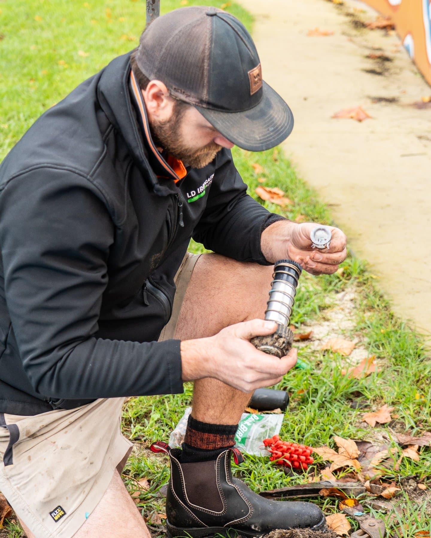 Lachlan from LD Irrigation Services repairing a sprinkler component on site